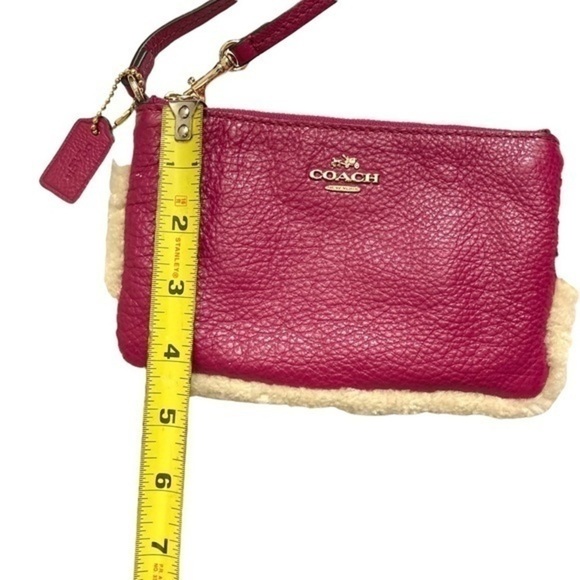 Coach pink leather shearling wristlet bag